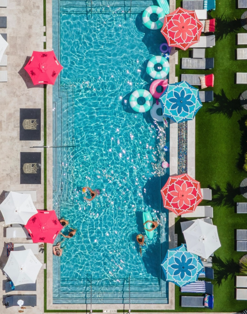 Aerial view of pool with colorful umbrellas